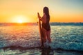 Woman with bodyboard catching breaking waves