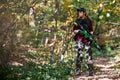 Woman bodyguard stands among the bushes