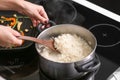 Woman boiling rice in kitchen Royalty Free Stock Photo