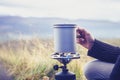 Woman boiling water on portable camping stove Royalty Free Stock Photo