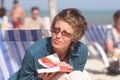 Woman with book on the beach