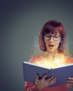 Woman, book and read for story, fairytale and wow facial expression for glowing and sparkle on mockup. Young person and Royalty Free Stock Photo