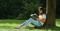 Woman with Book Relaxing in Park
