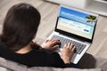 Woman Booking Vacations Packages On Laptop