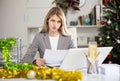 Woman bookkeeper doing paperwork in Christmas decorated office