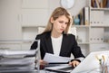 Woman bookkeeper doing paperwork in office