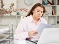 Woman bookkeeper doing paperwork in office