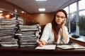 Woman bookkeeper using mobile phone at workplace Royalty Free Stock Photo