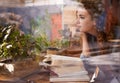 Woman, books and thinking by window in cafe for creative idea, reading inspiration and learning for knowledge. Student