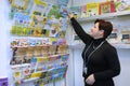 Woman bookseller places children books on a counter before opening a bookshop. Kiev, Ukraine