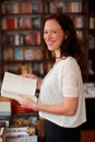 Woman, bookstore and portrait with sale, happy and pride for decision, choice or knowledge. Girl, novel and smile for Royalty Free Stock Photo