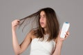 Woman with bootle shampoo loosing hair. Hair loss problem, baldness.