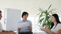 Woman boss holding meet with Young collaborators at desk in modern office