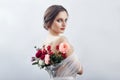 Woman with a bouquet of artificial flowers behind her. The girl in a light transparent dress with an open back and flowers. Art Royalty Free Stock Photo