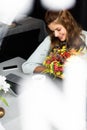 Woman with bouquet of autumn flowers in cafe with digital devices Royalty Free Stock Photo