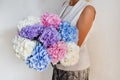 Woman with bouquet of hydrangeas. Beautiful fresh delicate flowers for holiday. Woman with beautiful flowers in her hands