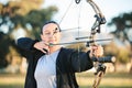 Woman, bow or arrows aim in sports field, shooting range or gaming ground for hunting, hobby or performance exercise Royalty Free Stock Photo
