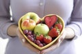 Woman bowl heart fruits organic. Generate Ai