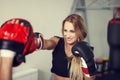 Woman boxer preparing in gym with instructor