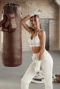 Woman boxer training with a punching bag in gym. Boxing girl wearing hand wrap Royalty Free Stock Photo