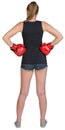Woman in boxing gloves standing akimbo