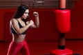 Woman boxing, hitting a punching dummy