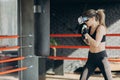 Attractive woman boxing in VR 360 headset training for kicking in virtual reality