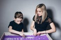 Woman and a boy draw on an interactive sand table Royalty Free Stock Photo