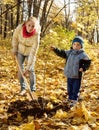 Woman and boy planting tree in autumn Royalty Free Stock Photo