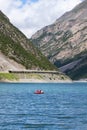 Woman with boy sailing on pedal boat on Lago di Livigno in Livigno, Italy