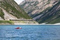 Woman with boy sailing on pedal boat on Lago di Livigno in Livigno, Italy