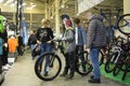 Woman and a boy standing near a bicycle just bought