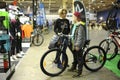 Woman and a boy standing near a bicycle just bought