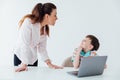 Woman with boy watching online laptop at table at school Royalty Free Stock Photo