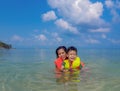 Woman and boy wearing a life jacket, scuba diving in the sea. Royalty Free Stock Photo