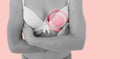 Composite image of woman in bra with breast cancer awareness ribbon Royalty Free Stock Photo