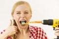 Woman with braces brushing teeth with drill Royalty Free Stock Photo