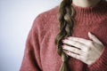 Woman with braid and nail polish wearing a pink warm soft glitter winter sweater Royalty Free Stock Photo