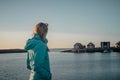 Woman with braided hair is enjoying view of beautiful holiday houses in Norway Royalty Free Stock Photo