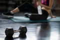 Woman break after dumbbell exercise in gym