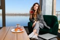 Woman at breakfast with tea and laptop Royalty Free Stock Photo