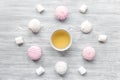 Woman breakfast with tea and marsh-mallow light wooden table top view Royalty Free Stock Photo