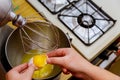 Woman breaks the egg into a mixer bowl and separating egg whites from egg yolks Royalty Free Stock Photo