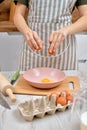 Woman breaks eggs in bowl. housewife cooking on kitchen Royalty Free Stock Photo