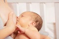 Woman breastfeed newborn infant with focus on baby face,