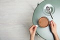 Woman brewing tea with bag in cup at table, top view Royalty Free Stock Photo