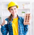 The woman with brick in construction concept Royalty Free Stock Photo