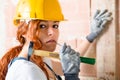 Woman Bricklayer with Hammer Royalty Free Stock Photo