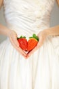 Woman bride hands holding some strawberries in her hands