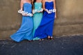 Woman bride maids in colorful blue dresses hold up a sign. Smile, love and dream